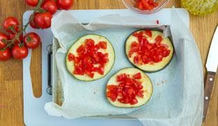 cospargere le fette di melanzane con i pomodorini cospargere le fette di melanzane con i pomodorini